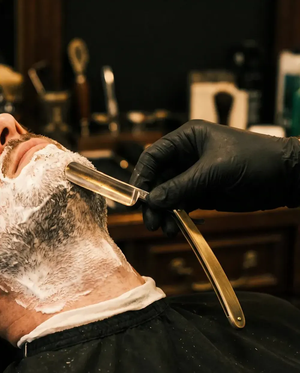 A straight razor along the neck line after the hot towel