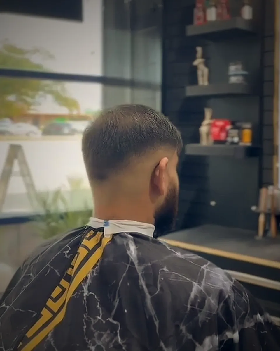 A finished fade from behind, by the shop's front window
